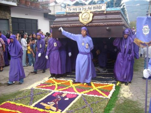 Head of the procession stepping on the alfombra after Noah's Ark was moved out of the way.